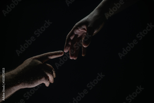 Two hands at the moment of farewell. The holding hands of relations. Help friend through a tough time. Rescue gesture, support, friendship and salvation concept. Hand creation of adam. © Volodymyr