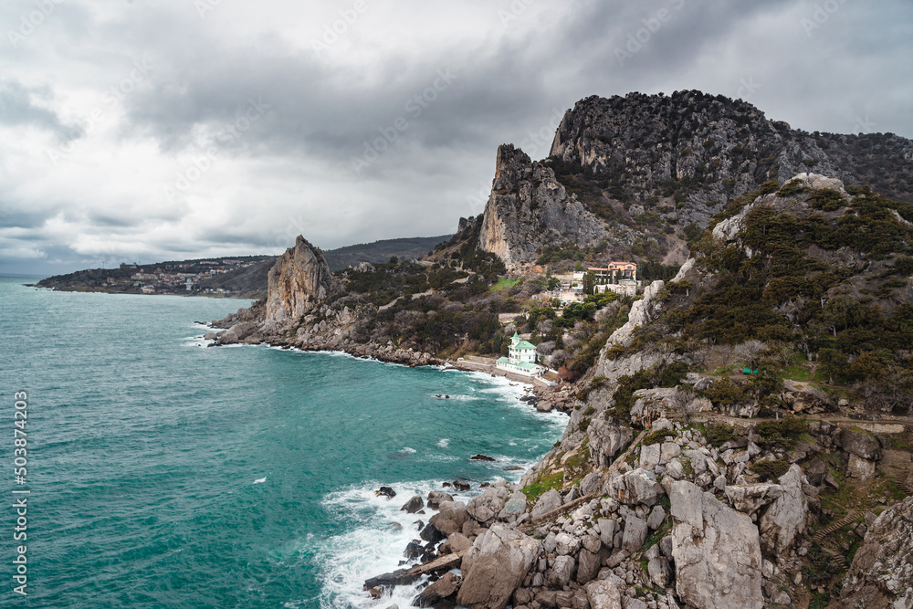 Coastal seascape landscape with Mount Cat or Koshka from rock Diva on cloudy weather. Simeiz, Crimea