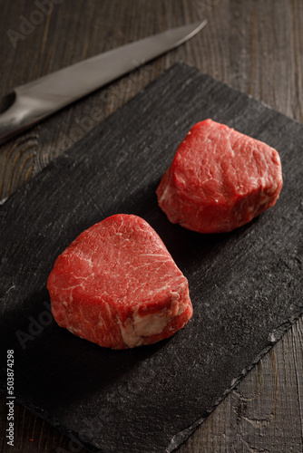 raw filet mignon on a cutting board