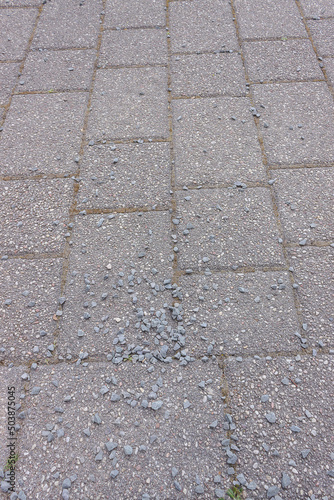 gray brick road on it lies pebbles