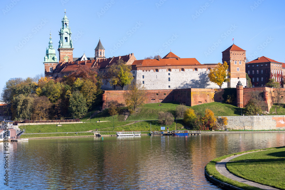 Wawel Royal Castle on autumn day, facade of building with colorful leaves of wild wine creeper, Krakow, Poland