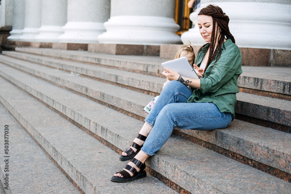 Earn extra money, Side hustle, money making, Gig economy, hustling, digital nomad. Side Jobs to Make Some Extra Money. Young woman, student with tattoo and dreadlocks working outside Earn extra money, Side hustle, money making, Gig economy, hustling, digital nomad. Side Jobs to Make Some Extra Money. Young woman, student with tattoo and dreadlocks working outside