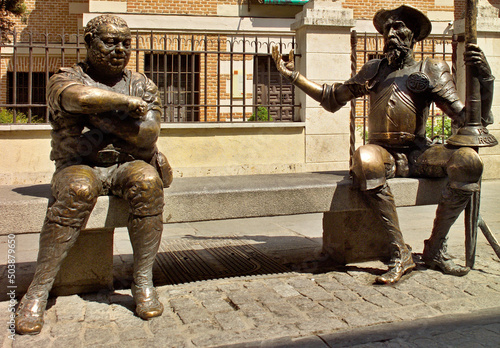 Statue of Don Quixote and Sancho Panza on a street bench in the Cervantes Museum House in Alcalá de Henares, Madrid - Spain photo