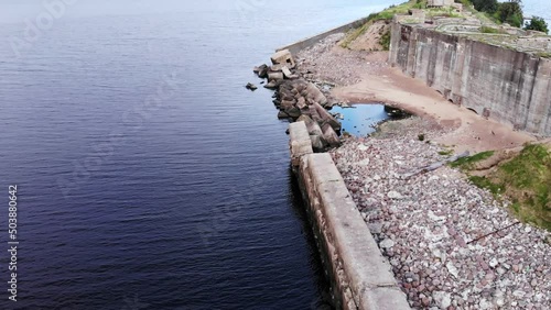 Ground from dam was washed away, and outer wall of island-fortress collapsed. Aerial of ruined and abandoned fortress on artificial island, remains of Fort Obruchev, the Gulf of Finland near Kronstadt