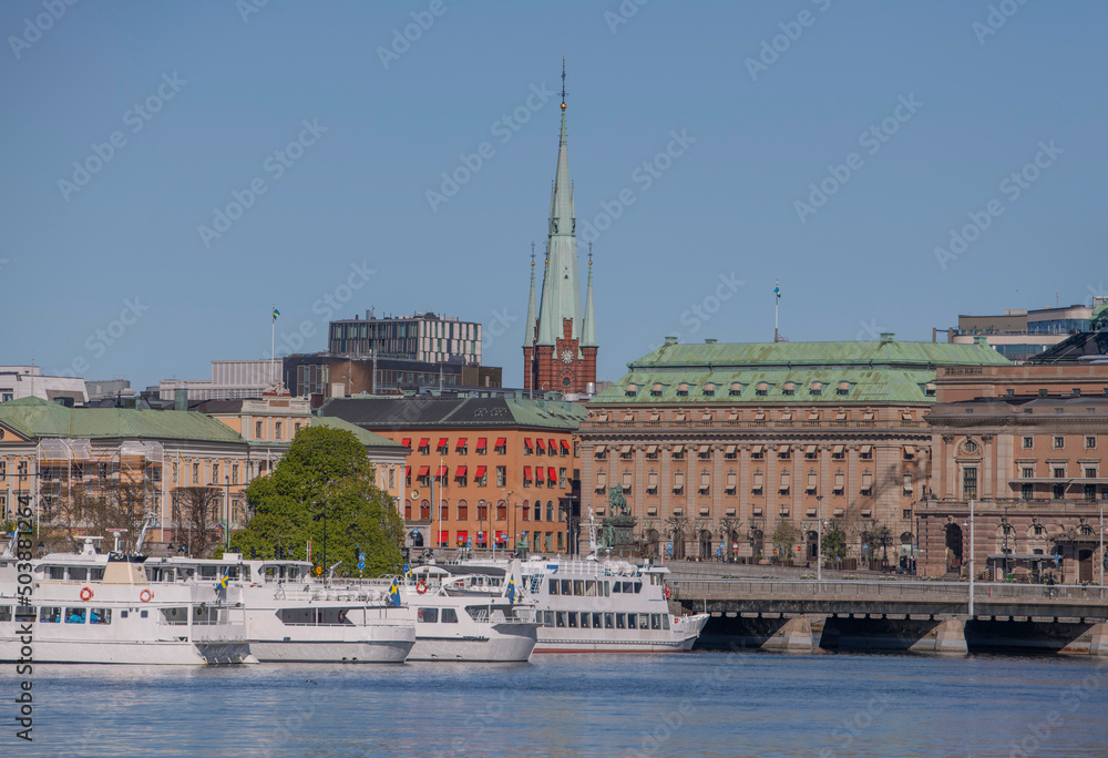 Panorama view over the bay Strömmen with commuting- and tourist boats and buildings a sunny spring day in Stockholm