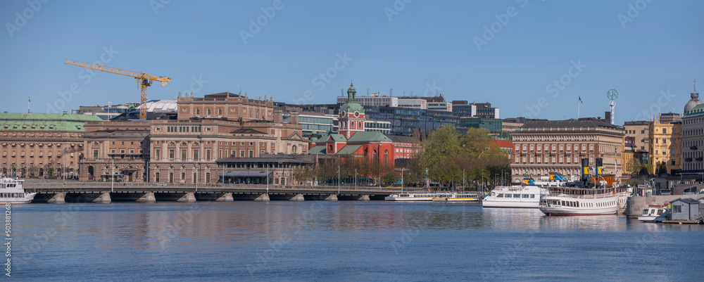 Panorama view over the bay Strömmen with commuting- and tourist boats at opera building a sunny spring day in Stockholm