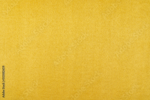 Background of orange suede fabric closeup. Velvet matt texture of orange nubuck textile