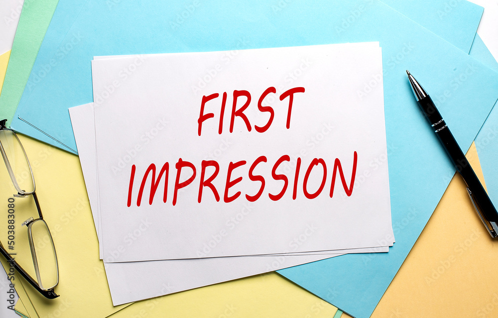 FIRST IMPRESSION text on paper on the colorful paper background