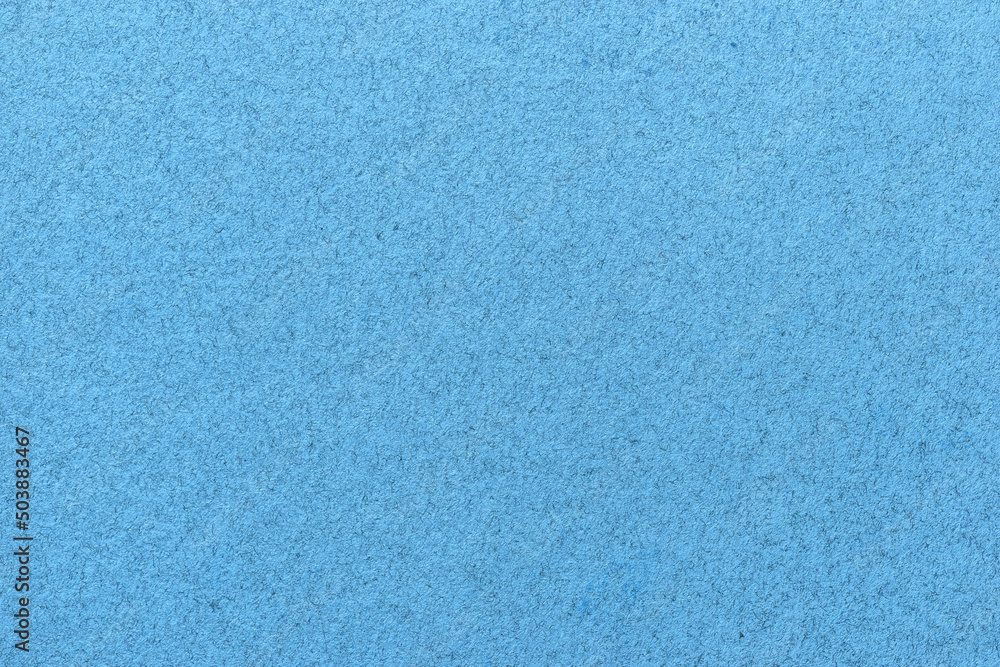Texture of old light blue paper closeup. Structure of a matte dense sky cardboard wallpaper. Texture of old light blue paper closeup. Structure of a matte dense sky cardboard wallpaper.
