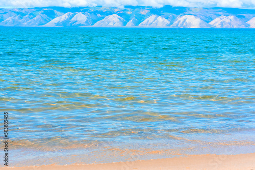 Water of the Lake Baikal at sunny summer day close up with selective focus. Beauty of nature, travel concept