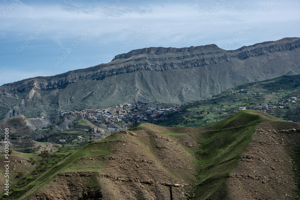 panoramic view of the alpine settlements in the mountains of Dagestan against the backdrop of mountains and the sky