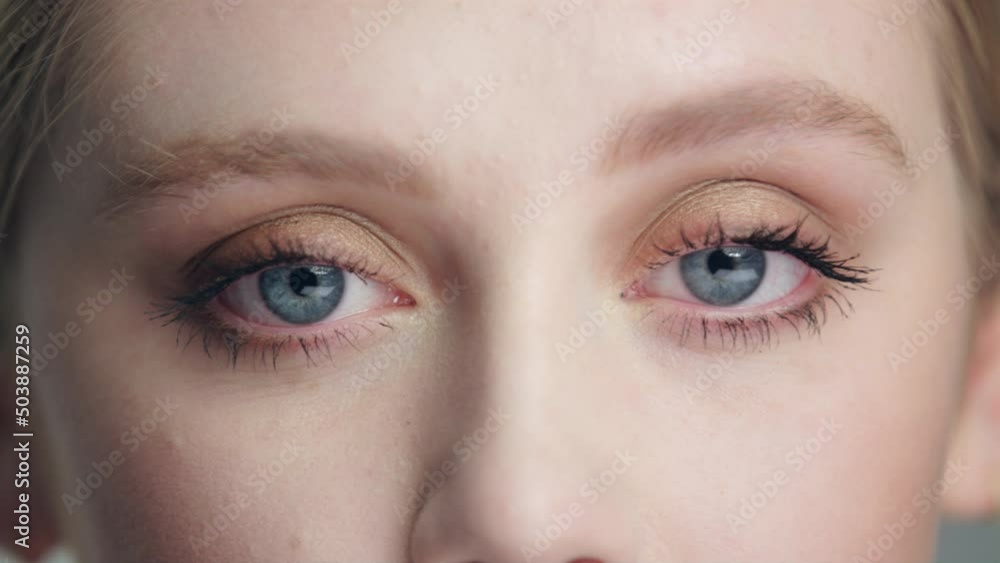 Extreme close pretty Caucasian model's eyes open straight into camera Extreme close pretty Caucasian model's eyes open straight into camera