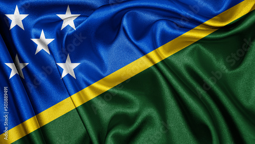 Close up realistic texture fabric textile silk satin flag of Solomon Islands waving fluttering background. National symbol of the country. 7th of July, Happy Day concept 