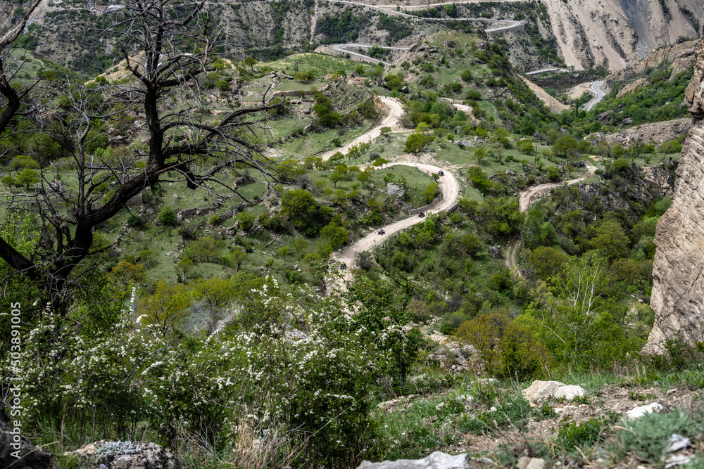 Fototapeta premium beautiful mountain peaks are buried in clouds and surrounded by winding mountain roads