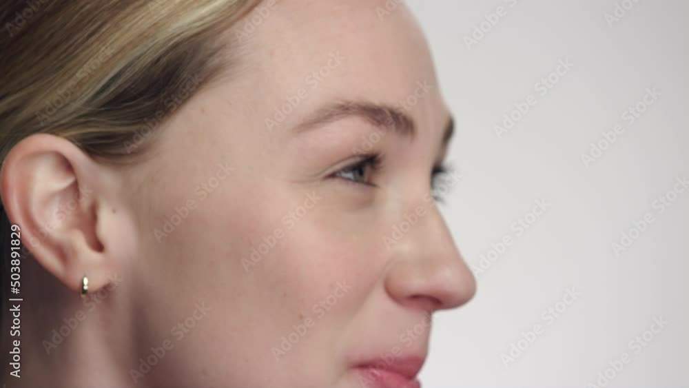 Extreme close up on happy caucasian model looking up to someone off camera Extreme close up on happy caucasian model looking up to someone off camera
