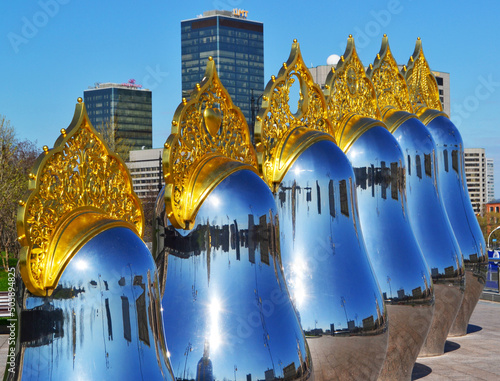 nesting dolls with golden kokoshniks on the background of skyscrapers photo