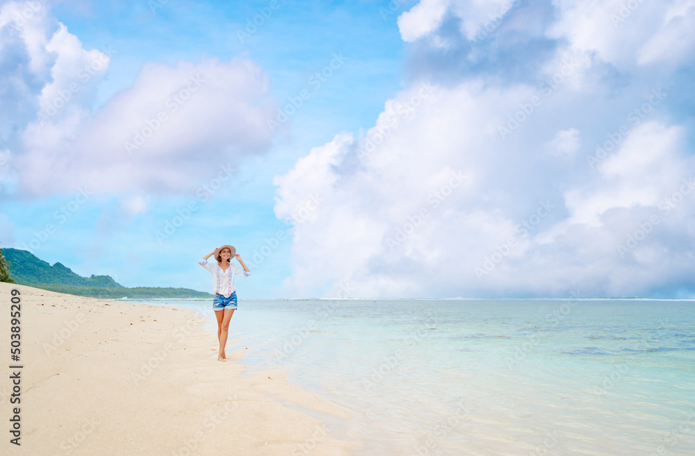 Vacation on the seashore. Young woman walking on the beautiful tropical white sand beach. Vacation on the seashore. Young woman walking on the beautiful tropical white sand beach.