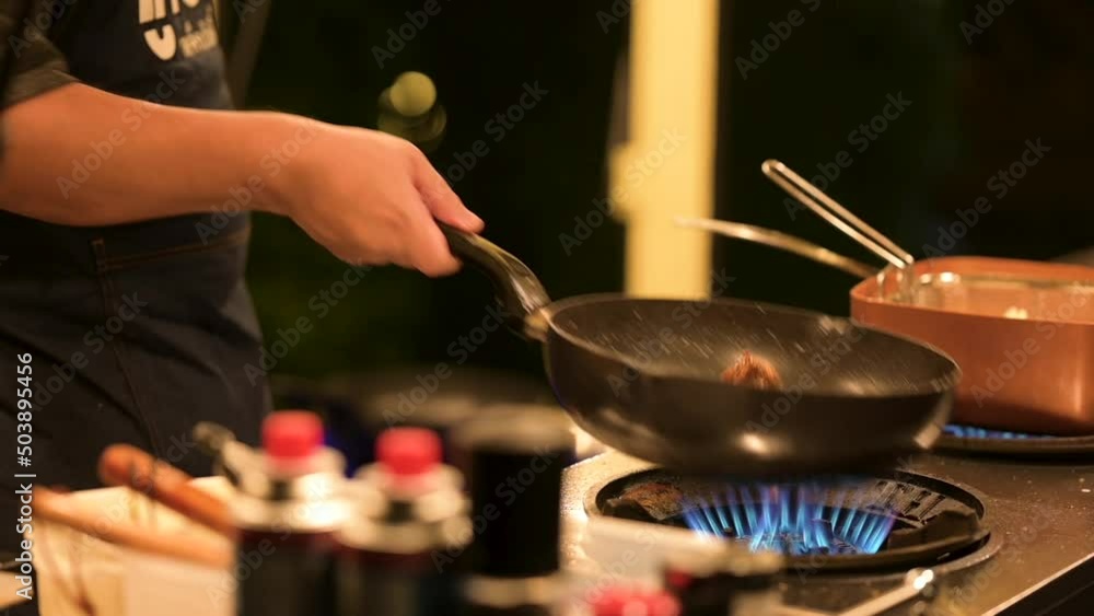 Asian Street food: Man Frying Vegetables in Wok at Night Food Market in Chinatown. Bangkok, Thailand. Asian Street food: Man Frying Vegetables in Wok at Night Food Market in Chinatown. Bangkok, Thailand.