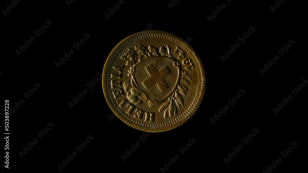 Rotating reverse of Switzerland coin 1 rappen 1941 with Latin name of Switzerland. Isolated in black background. Rotating reverse of Switzerland coin 1 rappen 1941 with Latin name of Switzerland. Isolated in black background.