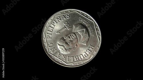 Rotating obverse of Philippines coin 1 piso 1978 with inscription meaning  REPUBLIC OF PHILIPPINES and portrait of Jose Rizal. Isolated in white background.