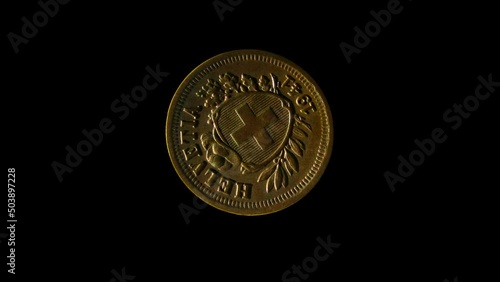 Rotating reverse of Switzerland coin 1 rappen 1941 with Latin name of Switzerland. Isolated in black background. photo