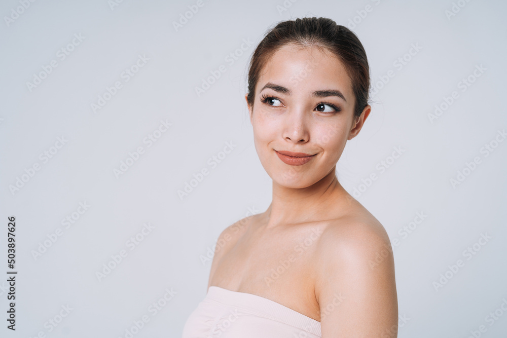 Beauty portrait of happy young beautiful asian woman with healthy dark long hair in top bando on white background isolated Beauty portrait of happy young beautiful asian woman with healthy dark long hair in top bando on white background isolated