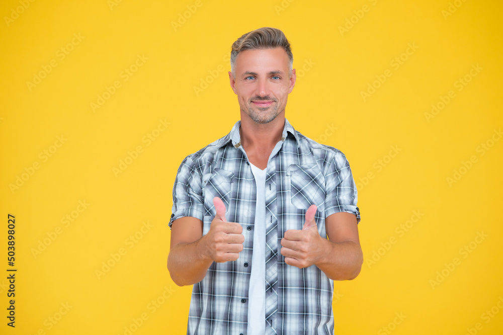 happy mature man with grizzle hair on yellow background. thumb up happy mature man with grizzle hair on yellow background. thumb up