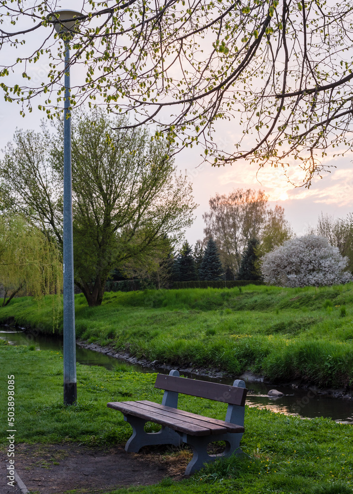 Sunset in spring park with river Sunset in spring park with river