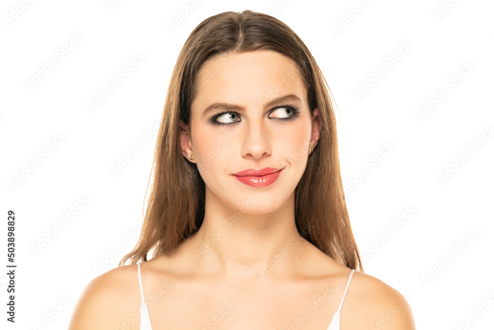 Image of thinking young lady with blue eyes, posing isolated over white background. Looking aside Image of thinking young lady with blue eyes, posing isolated over white background. Looking aside
