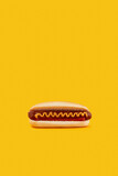 Classic hot dog with wurst, ketchup and mustard on orange background. Menu for restaurant