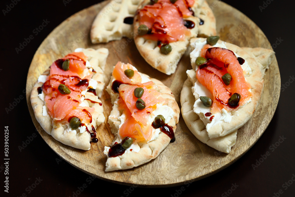 Pita sandwiches with salmon, cream cheese and capers. Healthy food. Keto diet. Pita sandwiches with salmon, cream cheese and capers. Healthy food. Keto diet.