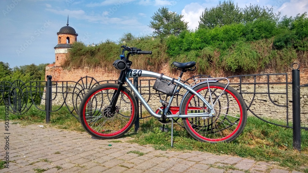 Bicycle cruiser on the background of the wall of the castle-fortress