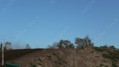 Dirt bikes long jumping on motocross circuit in Arnhem, the Netherlands photo