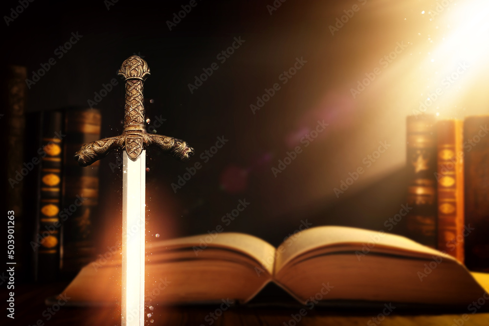 photo of sword and old books over dark background. Medieval period concept - obrazy, fototapety, plakaty 