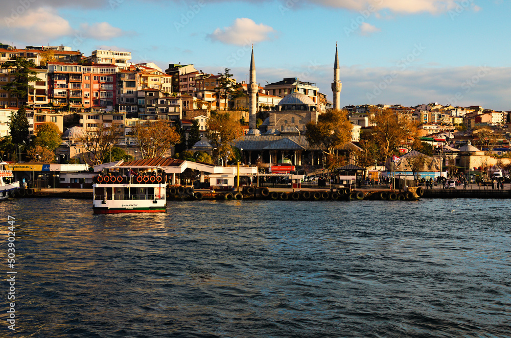 Fototapeta premium Istanbul, Turkey-October 25, 2021:Picturesque landscape view of residential buildings on the green hills along the Bosporus (Bosphorus or Strait of Istanbul). Clouds over the city