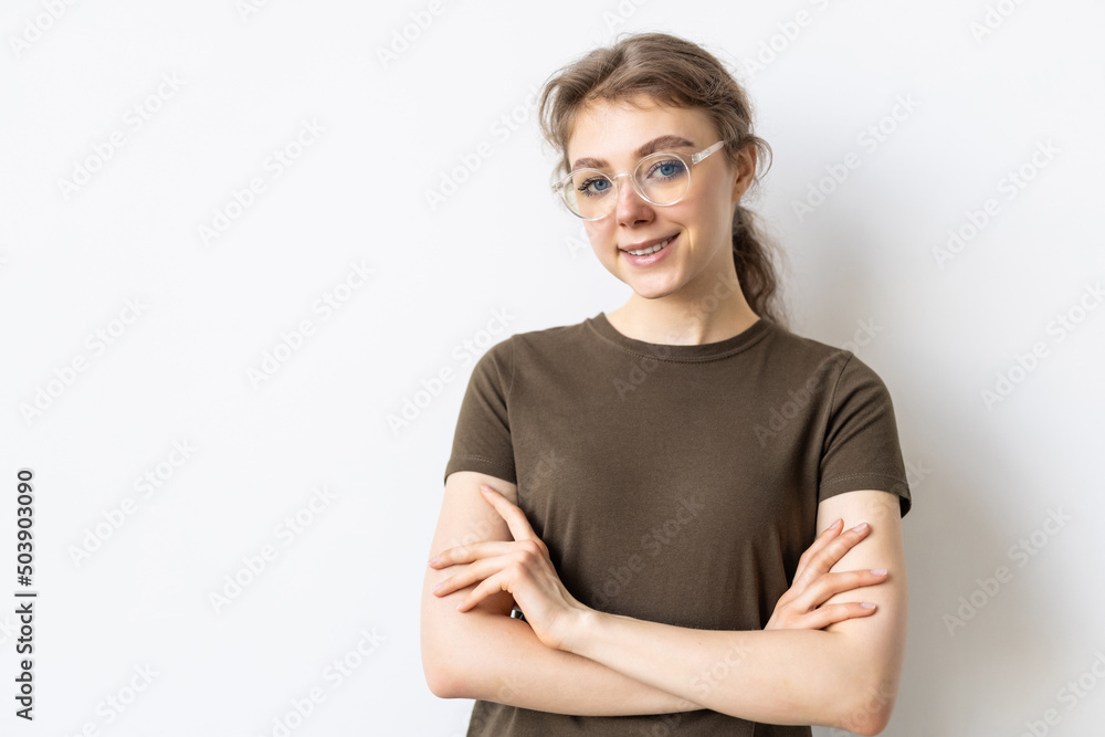 Portrait of confident woman feeling ready and determined, cross arms on chest self-assured looking at camera, standing against white background