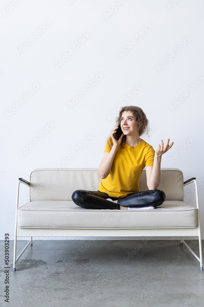Pretty young woman using white mobile phone at home Pretty young woman using white mobile phone at home