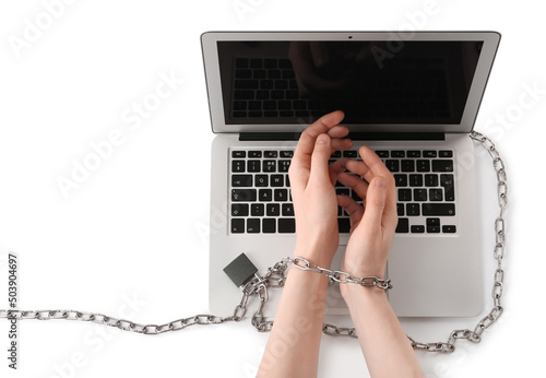 Woman showing hands chained to laptop on white background, top view. Internet addiction