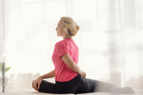 Portrait of attractive blonde girl in sportswear having training at home