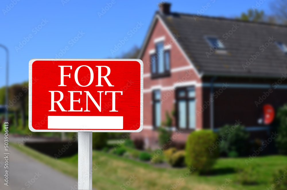 Sign with phrase FOR RENT and blurred view of beautiful house Sign with phrase FOR RENT and blurred view of beautiful house
