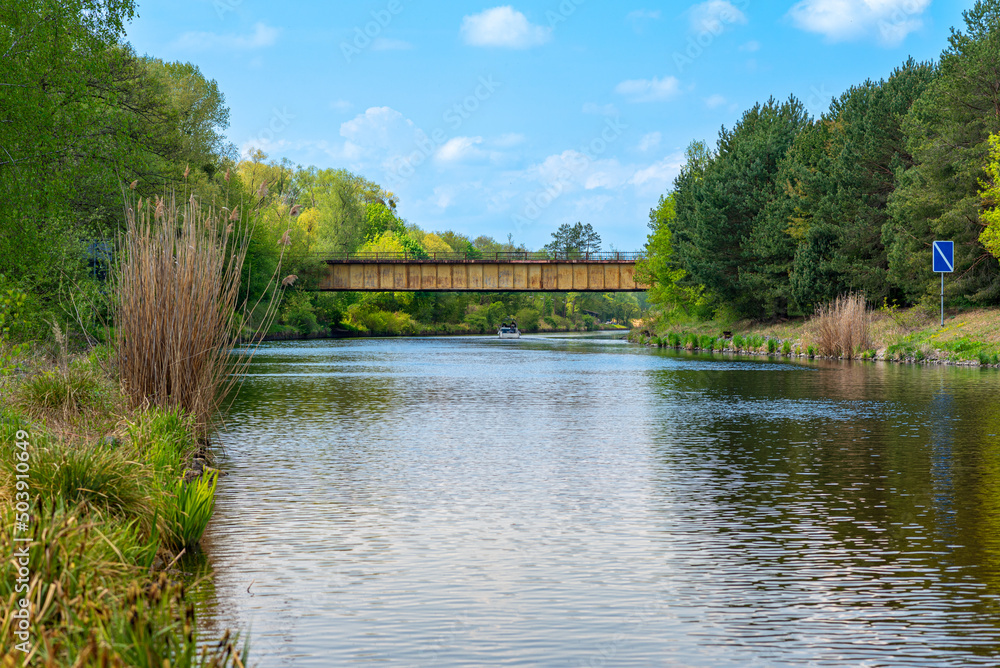 Fototapeta premium The Teltow Canal with the former highway bridge, Teltow canal bridge, and the former checkpoint Dreilinden in the south of Berlin. The Teltow Canal is one of the many waterways in and around Berlin