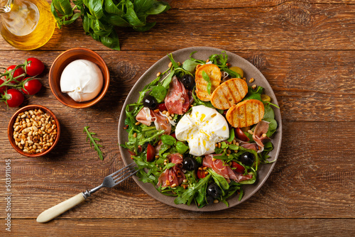 Salad with burrata cheese and croutons. photo