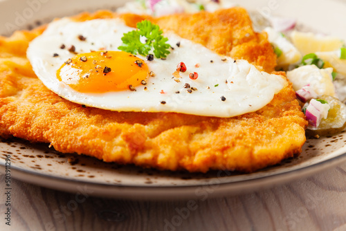 Photography Viennese pork schnitzel with a fried egg