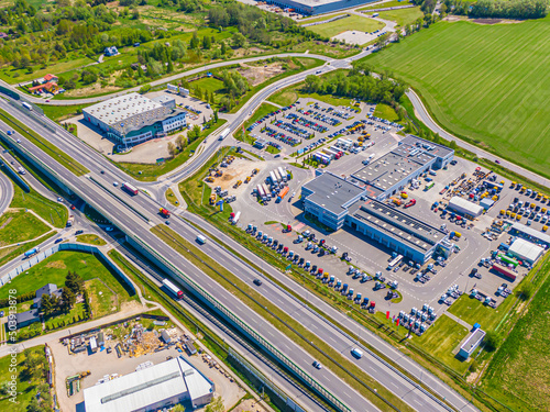 Aerial view of warehouse storages or industrial factory or logistics center from above. Top view of industrial buildings and trucks