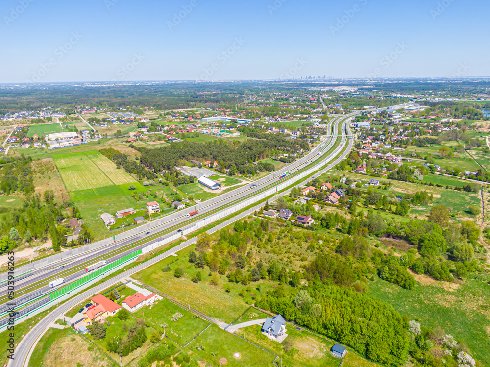 Aerial. Traffic on the intercity highway between the natural parkland. Top view from drone.