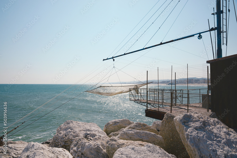 Shore operated stationary lift net on coast Shore operated stationary lift net on coast