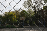 chain link fence against a basketball court