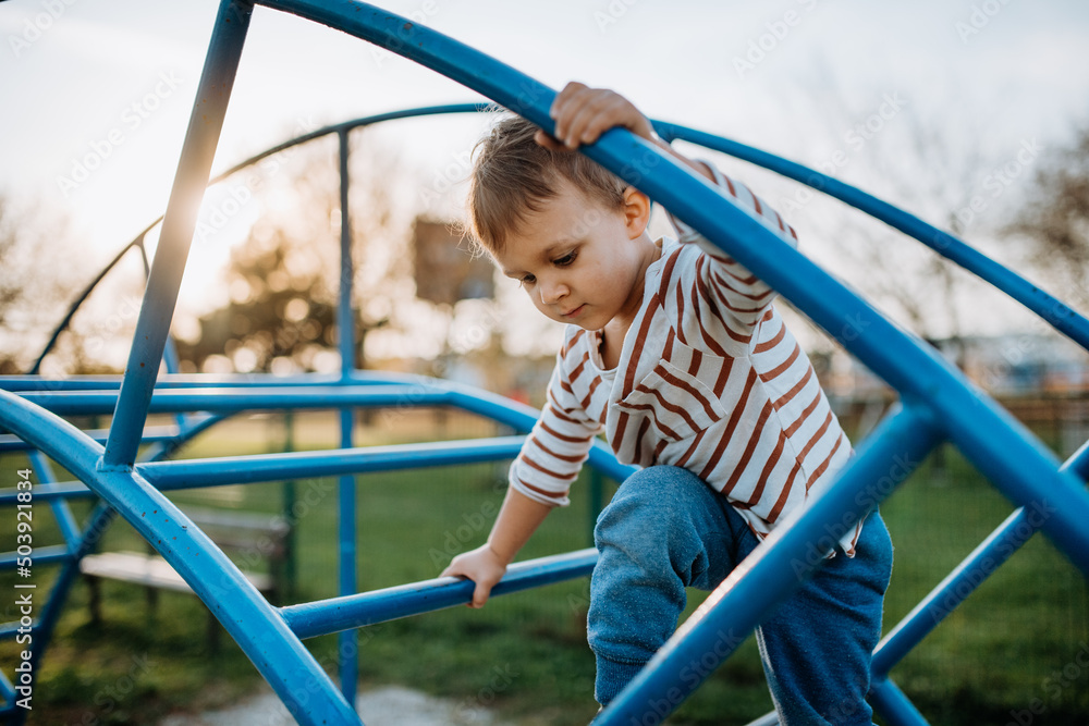 A little boy playing on outdoor playground. A little boy playing on outdoor playground.