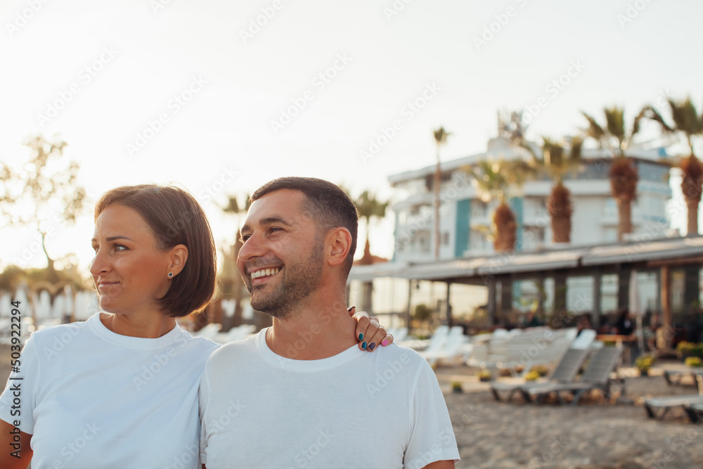 Happy portrait couple in love on the beach. Mixed family. Diverse couple on summer vacation