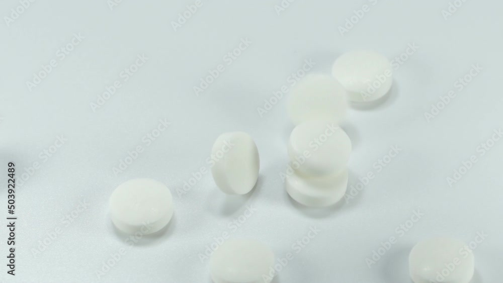 Close up slow motion medicine white color of pills rotation and pour the drug isolated on white background.Macro video. Close up slow motion medicine white color of pills rotation and pour the drug isolated on white background.Macro video.